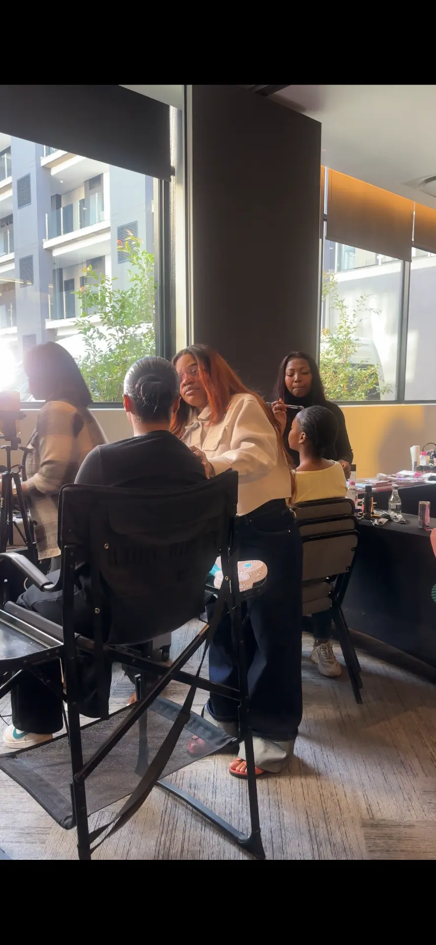 Students practising makeup techniques during a workshop