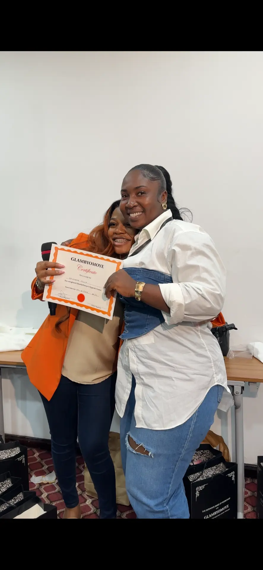 Omoye celebrating with a masterclass graduate and her certificate