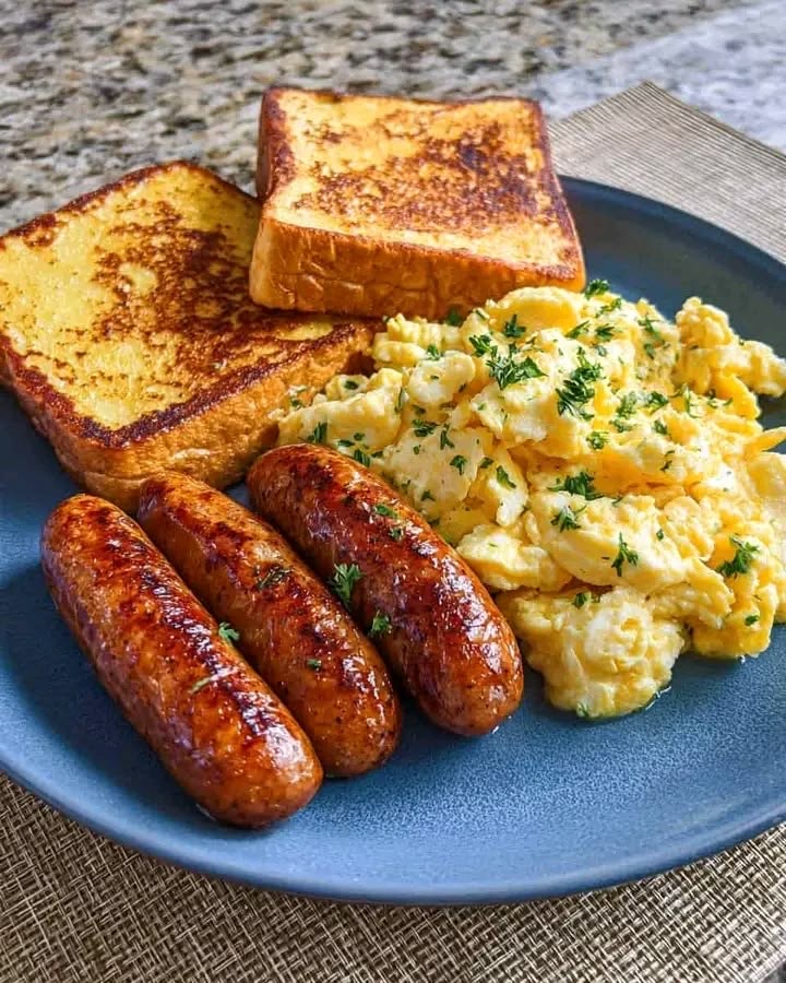 Breakfast plate with eggs, sausages and toast